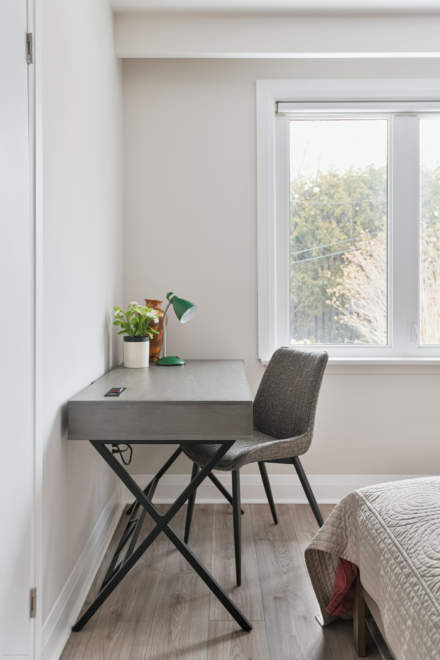 Primary suite with queen bed and desk